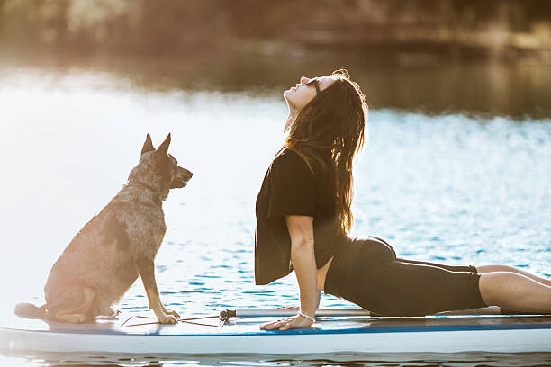 Fotografia Paddleboarding Woman With Dog