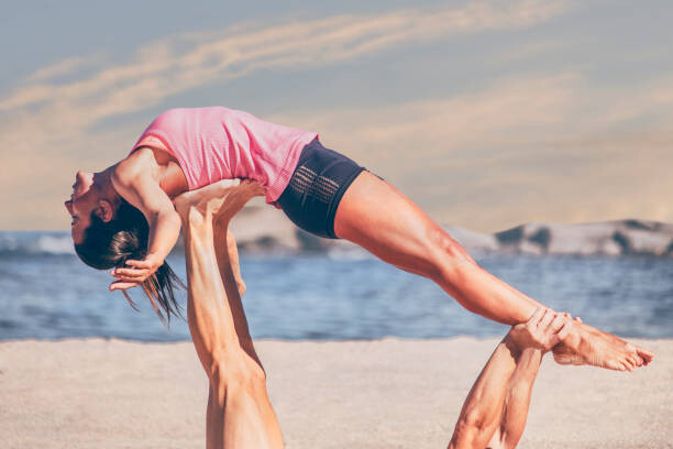 Fotografia Young sporty woman practicing acroyoga exercises