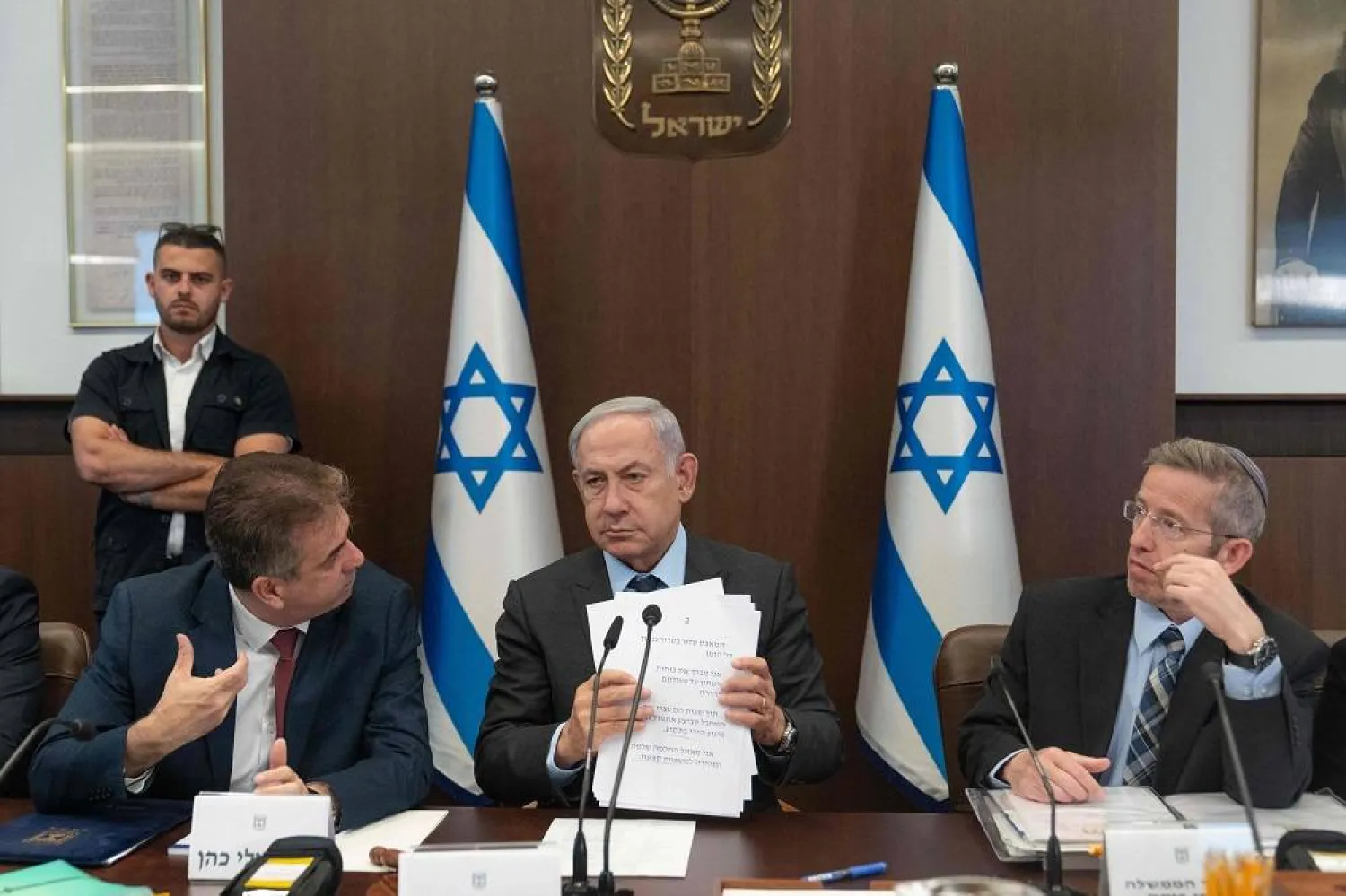 Israel's Prime Minister Benjamin Netanyahu (C) listens to Foreign Minister Eli Cohen (L), as cabinet secretary Yossi Fuchs (R) looks on during a weekly cabinet meeting at his office in Jerusalem, on July 17, 2023. (AFP)