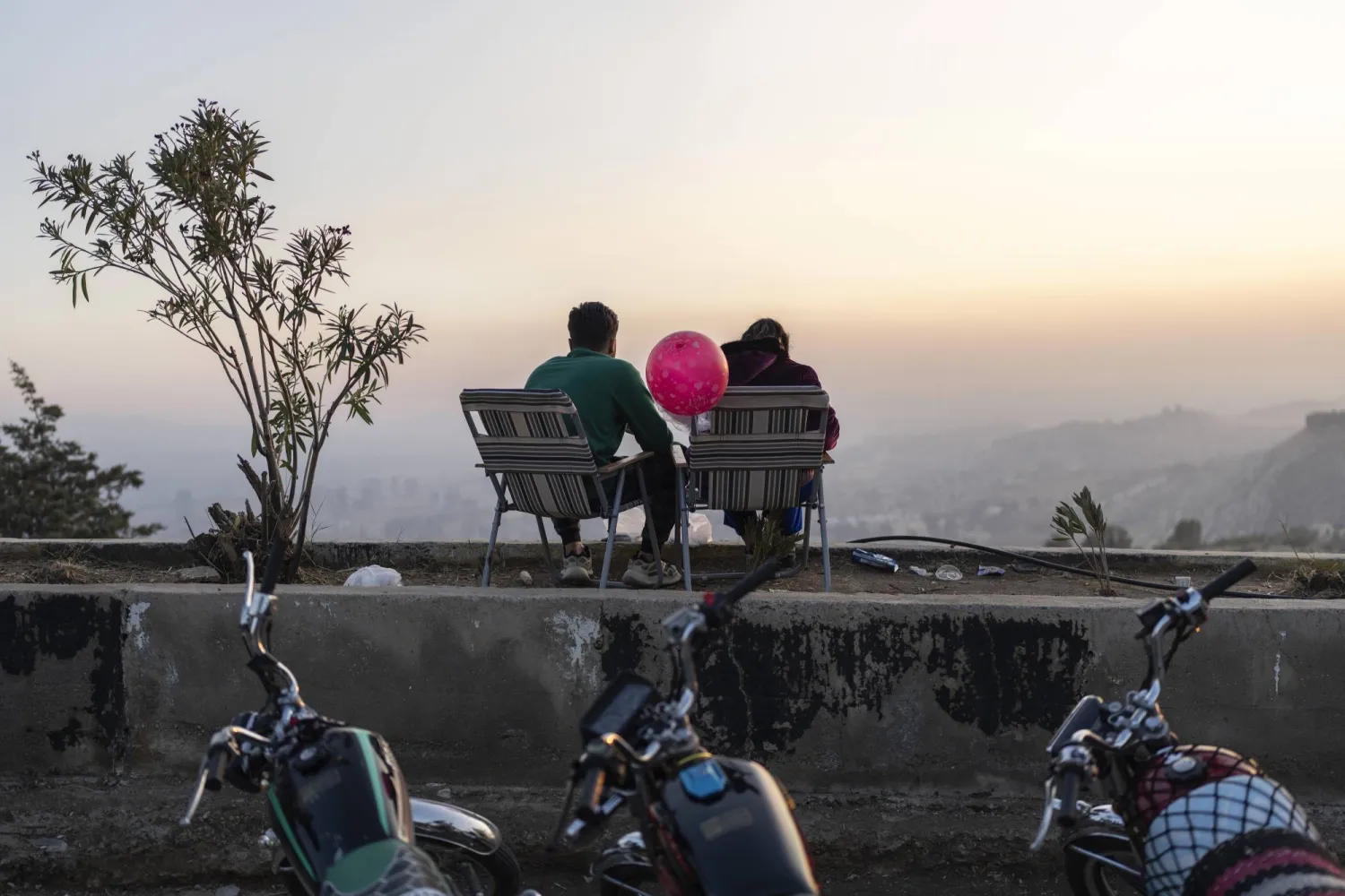 A couple watches the sunset atop Mount Qassioun, which was opened to the public after the fall of the Assad regime, in Damascus, Syria, Thursday, Jan. 2, 2025. (AP Photo/Mosa'ab Elshamy)