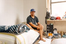 Jackson Villamarin Villegas sits on his air-mattress bed in his new third-floor walk-up apartment in the Sheepshead Bay neighborhood of Brooklyn.