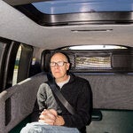 The New York Times reporter Cade Metz riding in a Zoox robot taxi in Foster City, Calif.