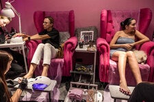 Viktoria Gulieva, right, gets her nails done at Kukla. Manicures are a small way for women to show that the war has not broken their spirits.