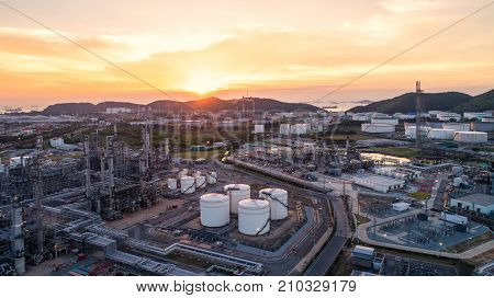 Aerial view Oil refinery.Industrial view at oil refinery plant form industry zone with sunrise and cloudy sky.Oil refinery and Petrochemical plant at duskThailand. Oil refinery background sunset.