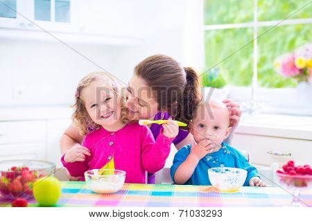 Mother And Kids Having Breakfast