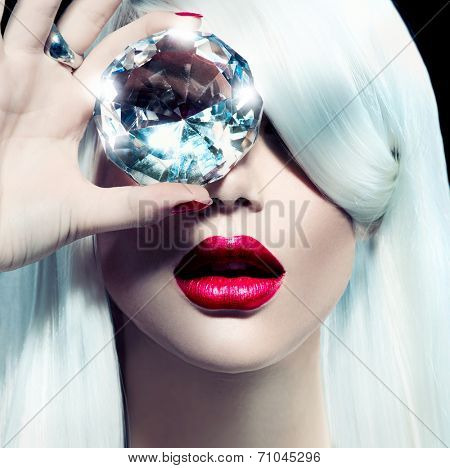 High fashion portrait of beauty model girl with a big diamond. Luxury make-up and accessories, white smooth shiny hair, red sensual lips