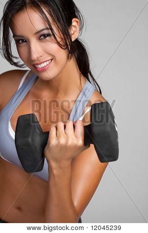 Smiling fitness woman lifting weights