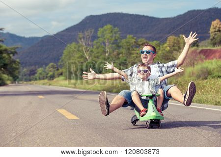 Father And Son Playing On The Road.