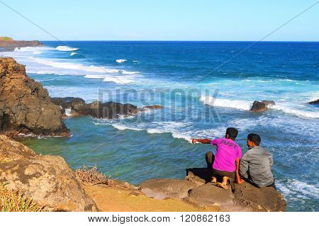 GRIS-GRIS, MAURITIUS ISLAND - 1. NOVEMBER, 2015: Unidentified tourists on sea cliff where the constant squashing of waves against the flanks of the cliff gives the impression that the cliff is crying.