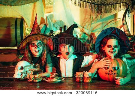 Surprised Group Little Zombie In Halloween Costume Eating Treat - Calaverita Sweets Candles. Funny H