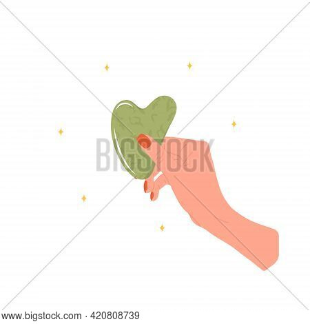 Gua Sha Scraper For Facial Massage. Female Hand Holding Natural Green Nephrite Stone. Trendy Beauty 