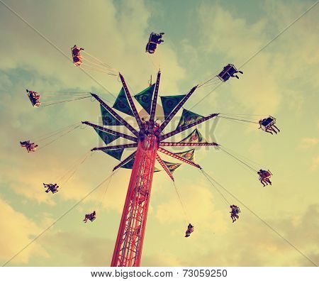  a fair ride shot with a long exposure at dusk toned with a retro vintage instagram filter 