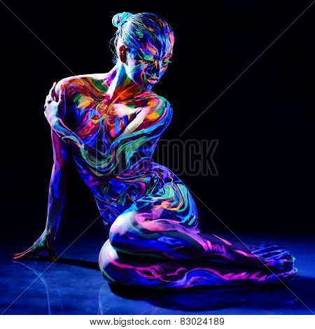 Charming nude girl with luminescent body art