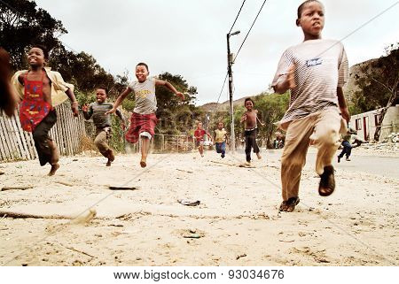 Children running in township, South Africa.