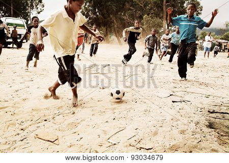 Children playing soccer in township, South Africa.