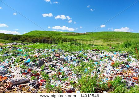 Garbage dump on green meadow