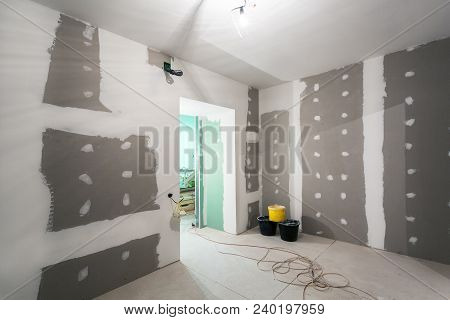 Metal Frames And Plasterboard -drywall- For Gypsum Walls, Three Buckets And Electric Wires  In Apart