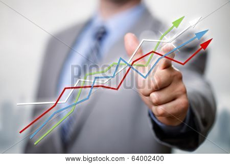 Businessman pointing to growth in a line graph showing business success