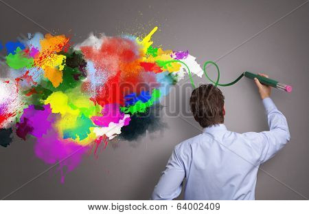 Businessman painting abstract colorful design on gray background concept for  business creativity, imagination and inspiration