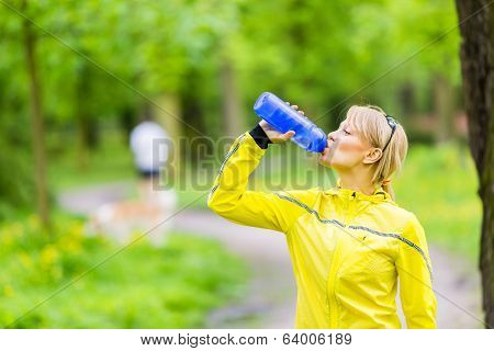 Female Runner Drinking Water