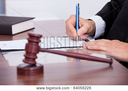 Male Judge Writing On Paper