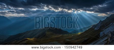 Mountain valley in beams of evening sun. View of Greater Caucasus Mountain Range from a mount Zagedan slope. Caucasus mountains. Karachay-Cherkessia. Russia.  