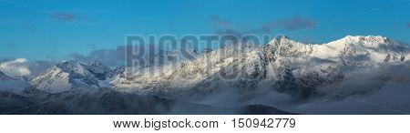 Snow-covered mountains at sunrise. Greater Caucasus Mountain Range. Caucasus mountains. Karachay-Cherkessia. Russia.  