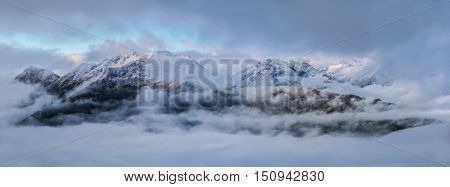 Dawn high in mountains on a foggy morning. Greater Caucasus Mountain Range. Caucasus mountains. Karachay-Cherkessia. Russia.  