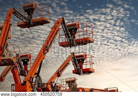 Articulated Boom Lift. Aerial Platform Lift. Telescopic Boom Lift Against Blue Sky. Mobile Construct