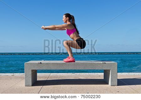 Hispanic Woman Doing Squats By The Water