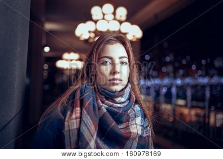 gorgeous brunette girl portrait in night city lights