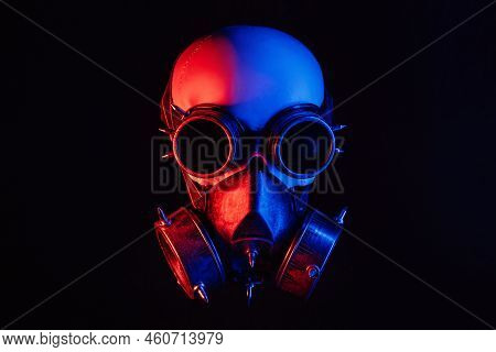 Human Skull In Steampunk Glasses And A Gas Mask With Red And Blue Neon Light On A Black Background