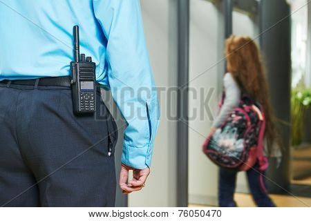 security guard controlling indoor entrance gate