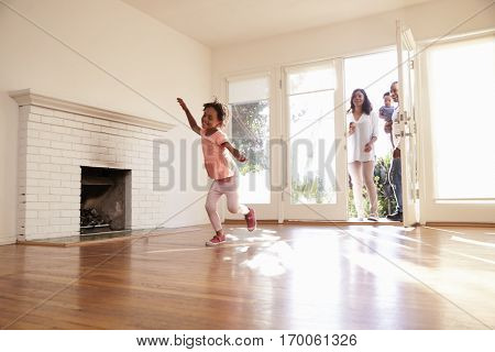 Excited Family Explore New Home On Moving Day