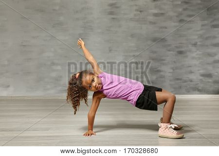 Cute African American girl in dance studio