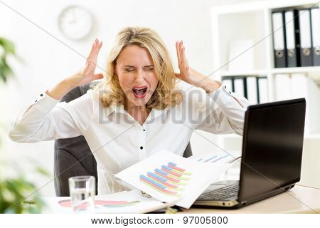 Stressed businesswoman at laptop in office