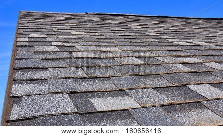 Newly Installed Roof with Textured Asphalt Shingles or Bitumen Tiles on the Rooftop Outdoor. Asphalt Tiles.