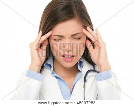 Doctor with headache stressed. Nurse / doctor with migraine headache overworked and stressed. Health care professional in lab coat wearing stethoscope isolated on white background.