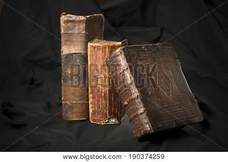 Old Book Spines On Black Background. Ancient Library. Antique Holy Scripture Books. Antique Books Co