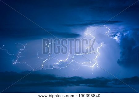 Thunder Storm Lightning Strike On The Dark Cloudy Sky Background At Night.