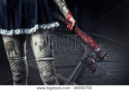 Dirty Woman's Hand Holding A Bloody Axe