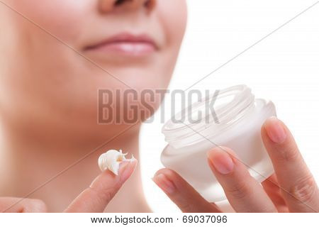 Skin Care. Girl Applying Moisturizing Cream.