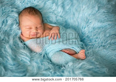 Happy Smiling Newborn Baby In Wrap, Sleeping Happily In Cozy Fur