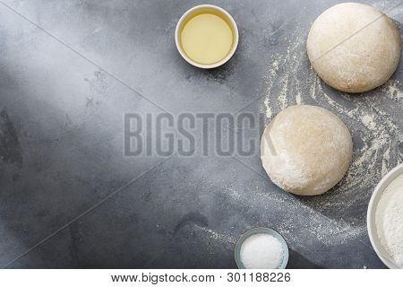 Risen Or Proved Yeast Dough For Bread Or Pizza On A Floured Slate Surface.