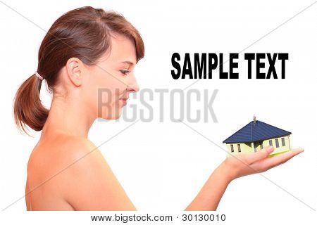 Attractive young woman holding little family house. Easy living and mortgage concept.