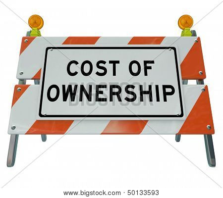 The words Cost of Ownership on a barricade to illustrate the prohibitive true price of a car, home or other item when considering added costs like fees, taxes, depreciation and other financial items