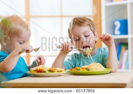 kids eating healthy food in kindergarten or nursery