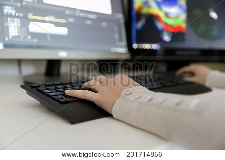 Female Video Editor Works With Footage On Her Personal Computer, She Works In Creative Office Studio