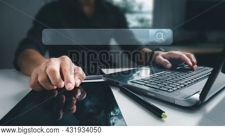 The Businessman Working With A Computer Laptop On A Desk In The Office. The Concept Is Search Engine