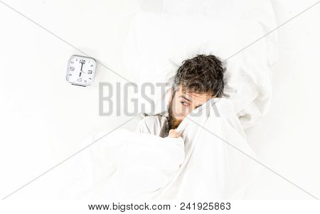 Guy Hides Face Under Blanket. Morning And Wake Up Concept. Man With Calm Face Lies On Pillow Under B